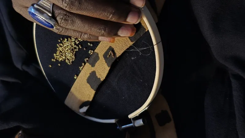 Embroidery hoop with gold beads on black fabric