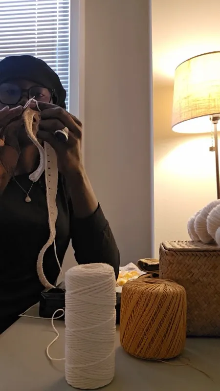 Diama crocheting at home with yarn spools